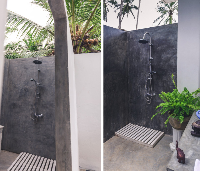 open air shower room under palm trees